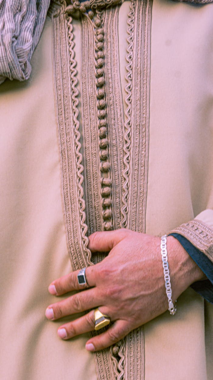 Detailed view of a hand on traditional Moroccan attire in Rabat, showcasing cultural elegance.